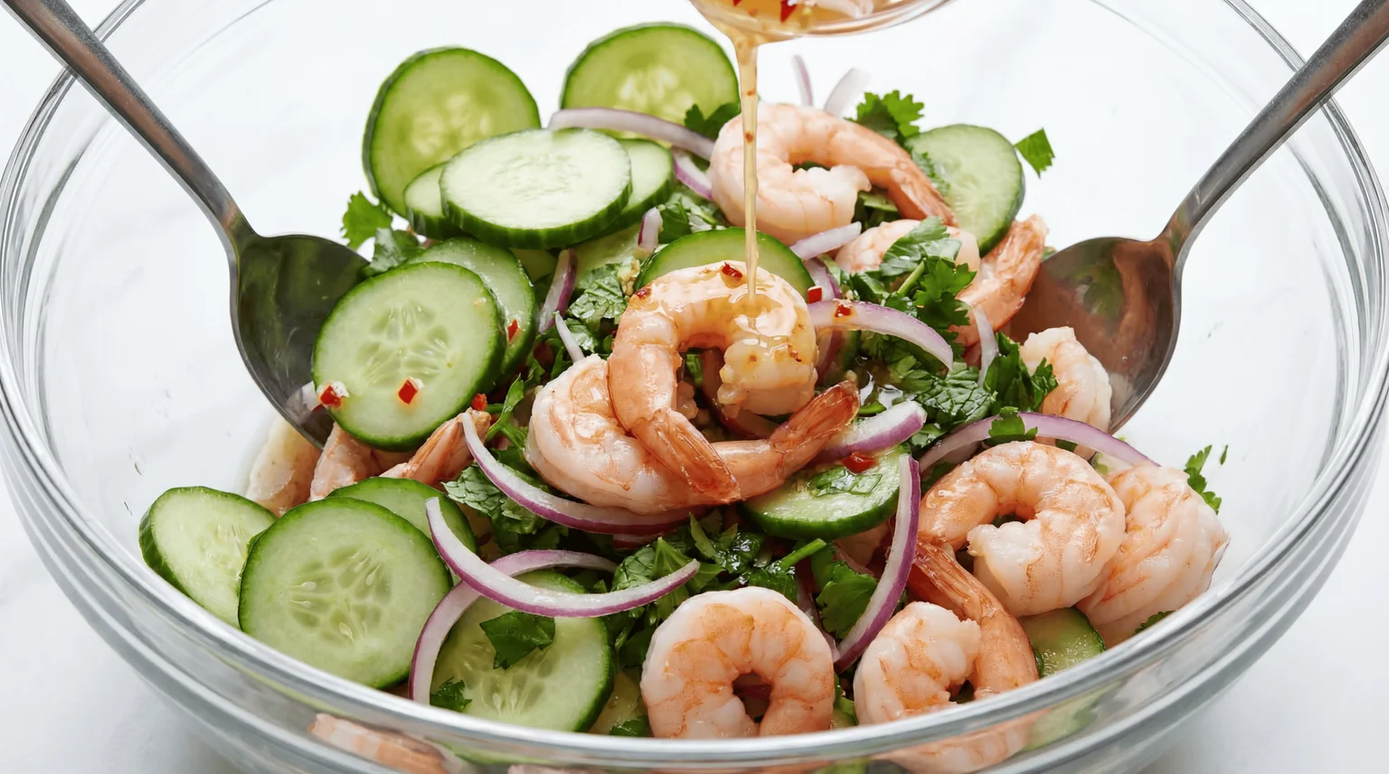 Tossing Thai Cucumber & Shrimp Salad with dressing