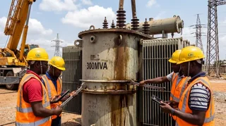 Electrical engineers installing a large power transformer at a Nigerian TCN transmission substation as part of the 2025 grid expansion programme