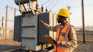 Electrical engineer inspecting transformer substation in Nigeria