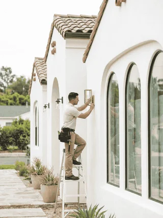 Professional home maintenance work on a residential property exterior