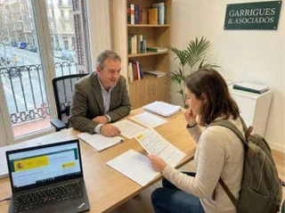 Residency and visa consultant reviewing documents with a client in Spain