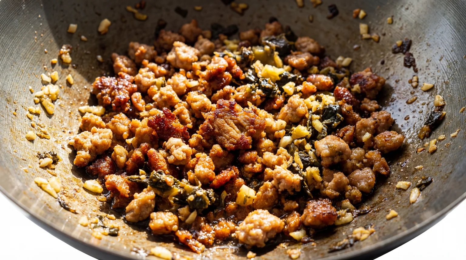 Crispy ground pork topping for Dan Dan Noodles cooking in wok with Ya Cai pickled mustard greens, garlic, and ginger — savory Sichuan meat sauce preparation